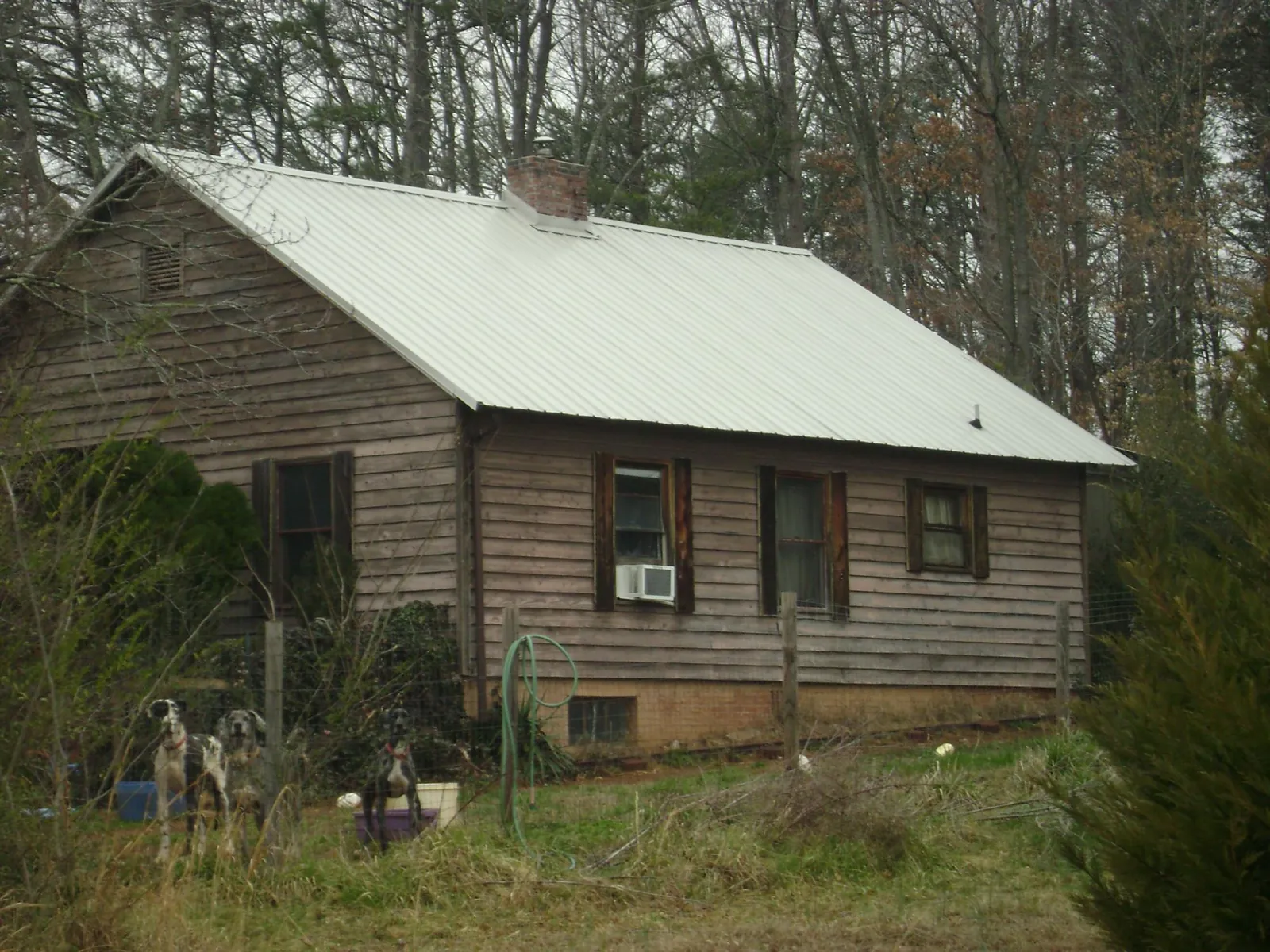 White metal roof on an old wood sided farmhouse, from a Metal Roof Installation job in Glenn Dale